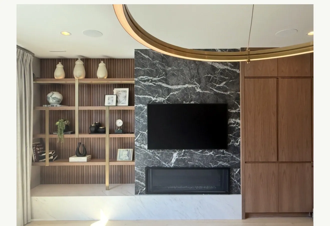 Hoboken living room with styled shelving and black marble fireplace