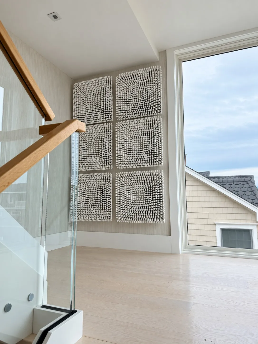 Six sculptural artworks beside a stair landing