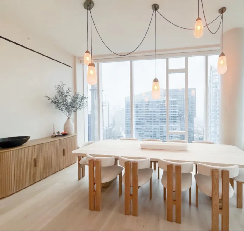 Dining room with wood furniture, pendant lights, and city views