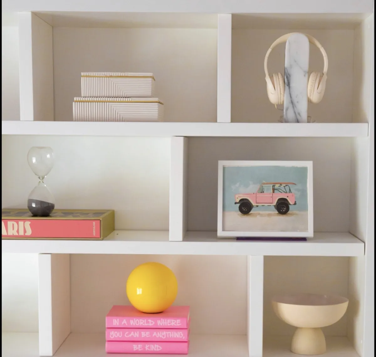 Styled shelf details with books and playful objects