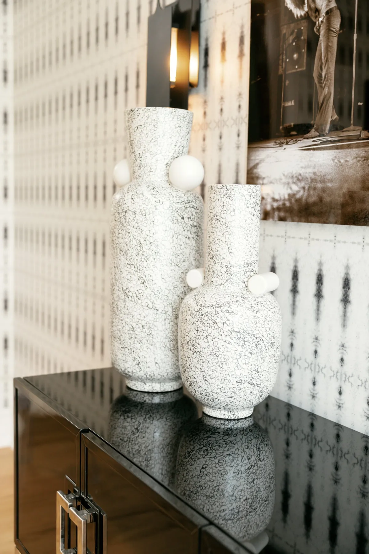 Textured white sculptural vases on a black lacquer console