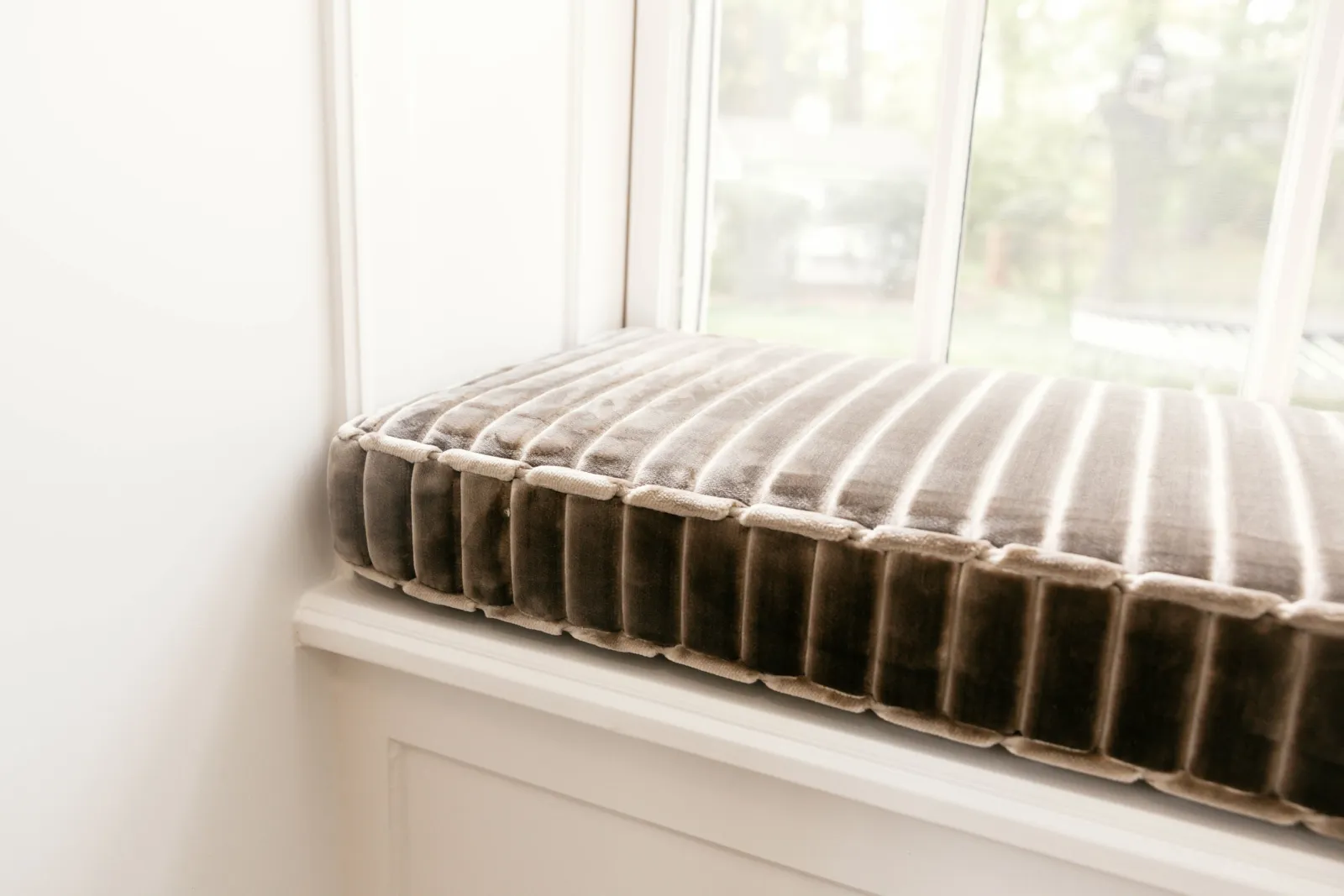 Tailored striped cushion on the window seat