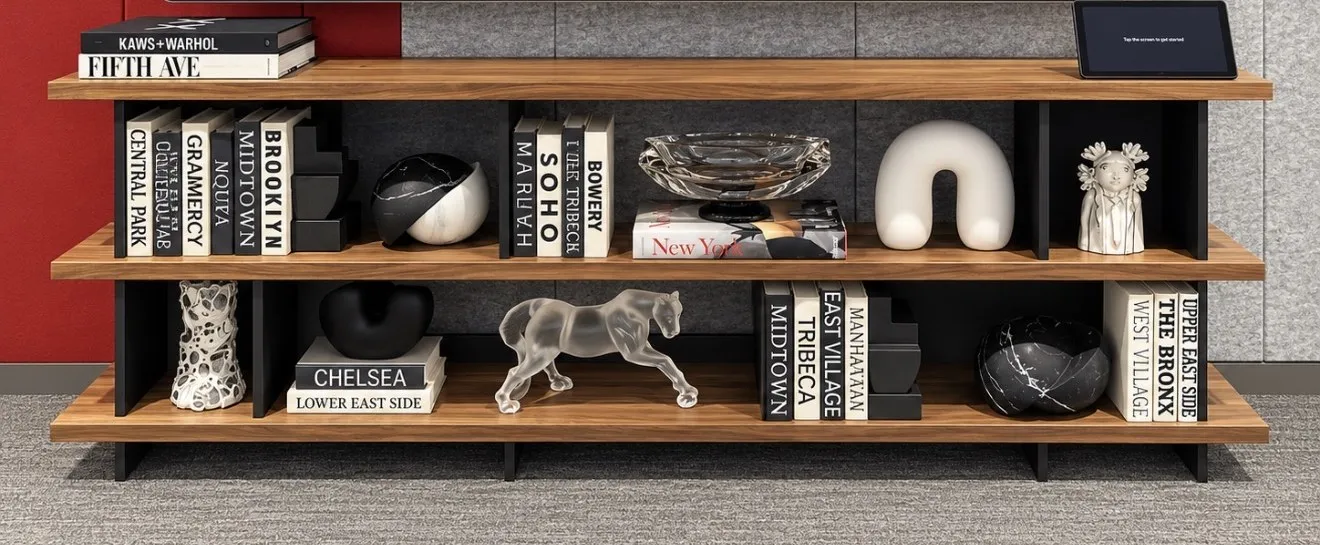 Media shelving styled with New York neighborhood books, a glass horse and sculptural objects